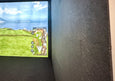 Acoustic tiles installed beside a golf simulator screen