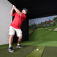 Golfer hitting into a Built-In Golf Room Kit screen
