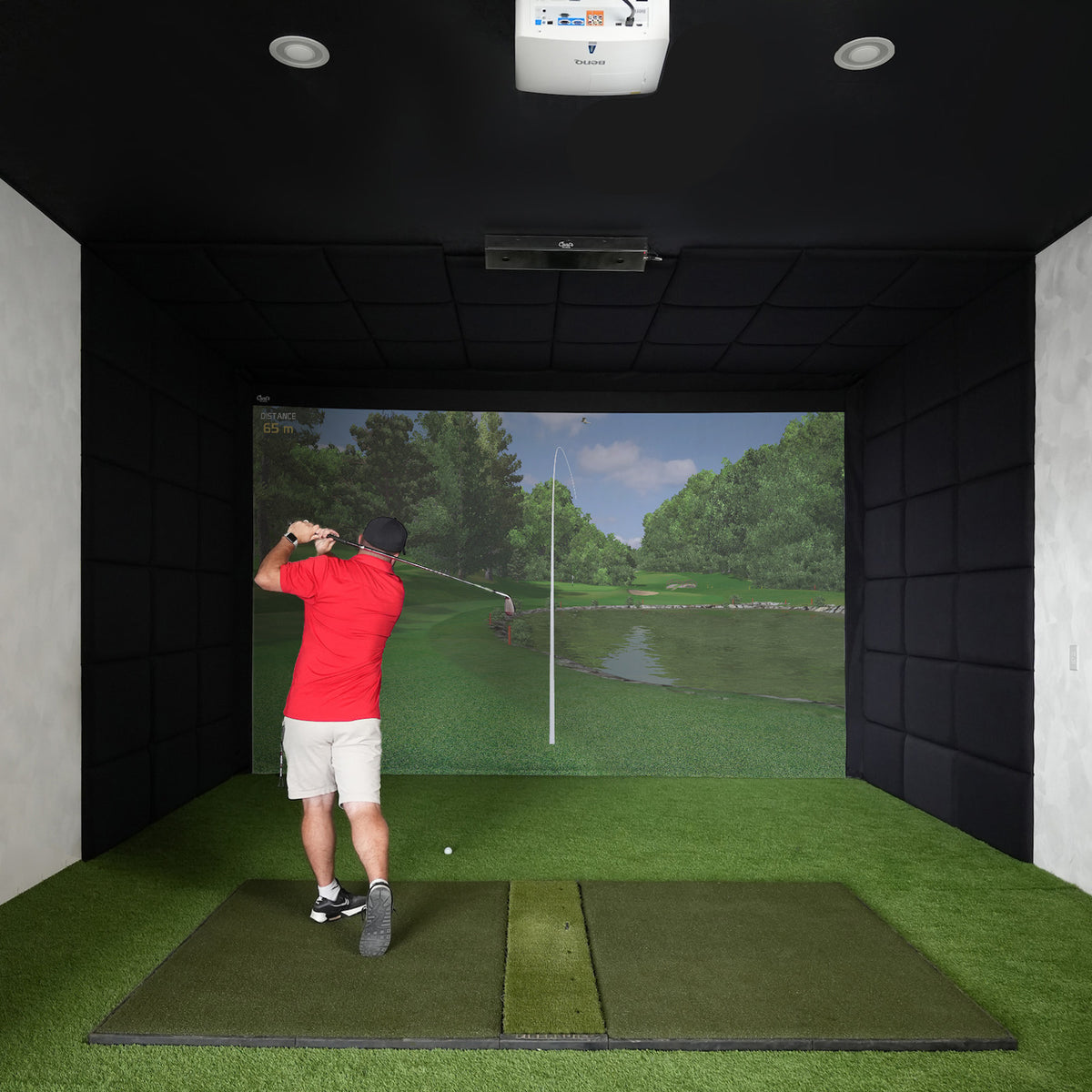Golfer swinging an iron in a built-in golf room