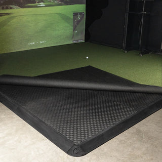 Golf room floor tiles installed as a subfloor with turf folded back in a golf simulator room